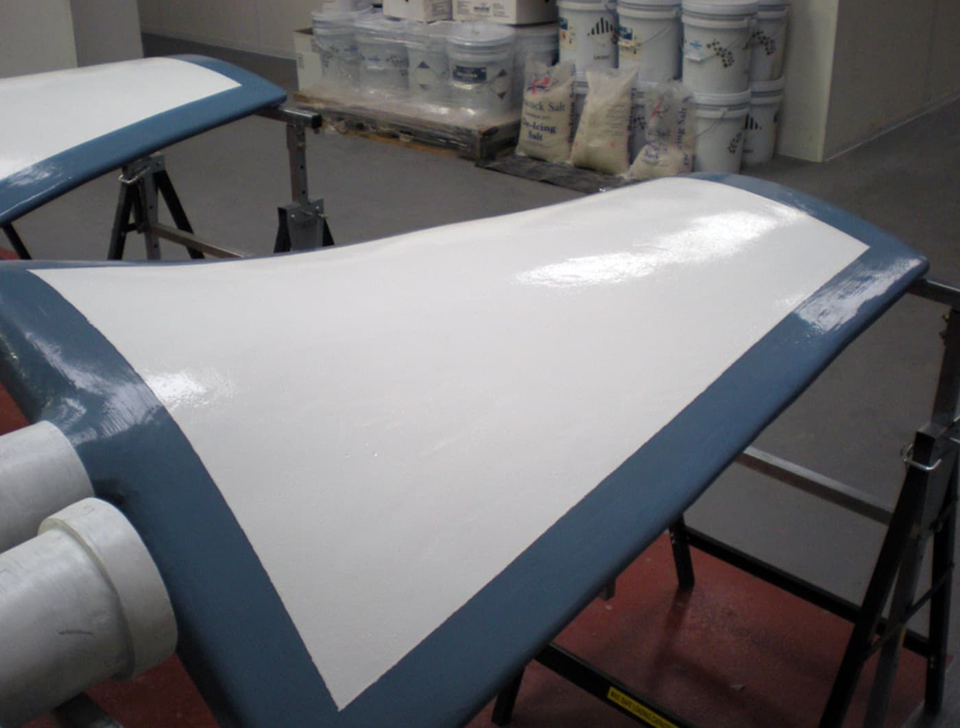 Induced draft fan blade leading edges rebuilt and coated for erosion protection