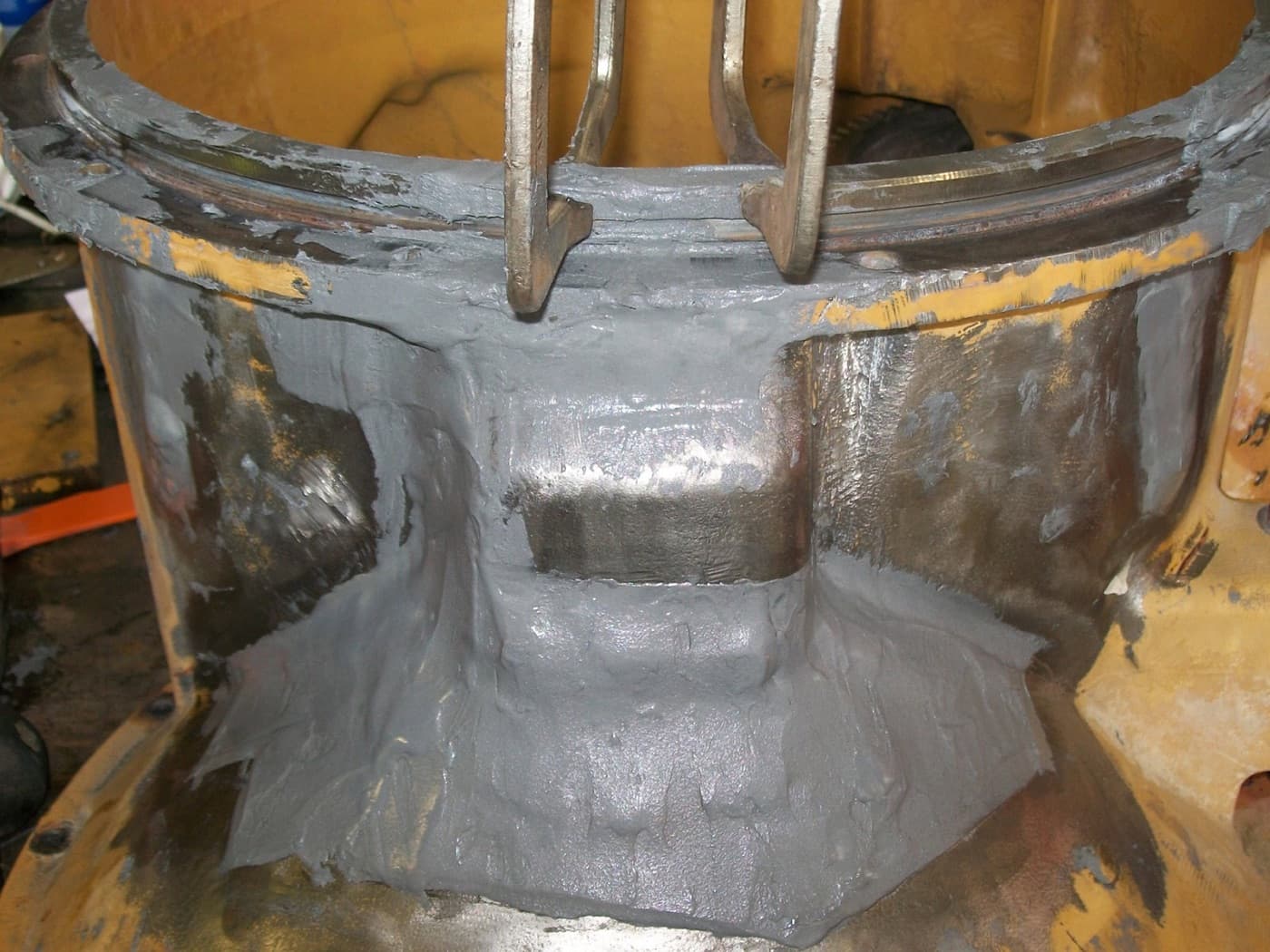Worn mill stand roll housing bore rebuilt with cold-applied composite